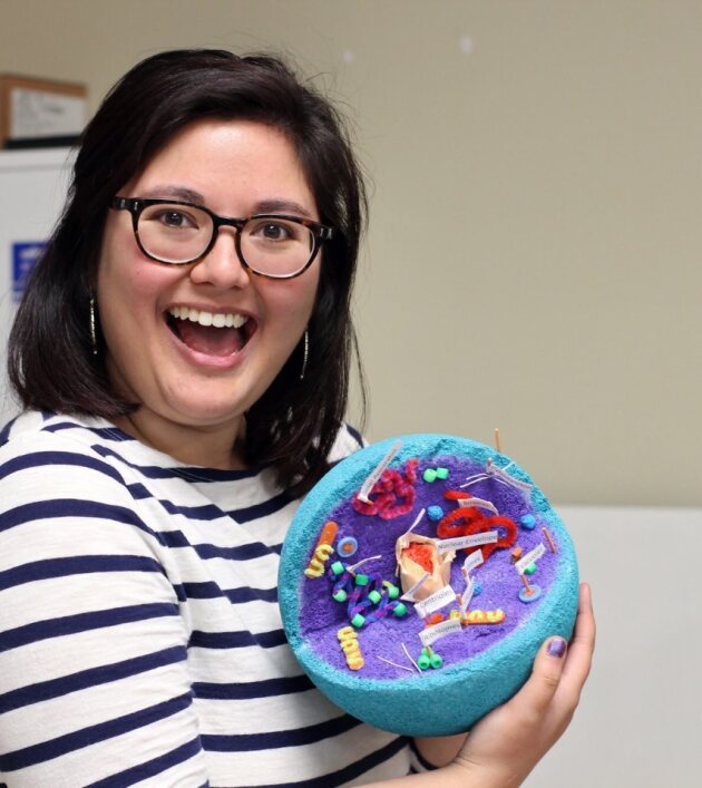 tnt student holding a cell model
