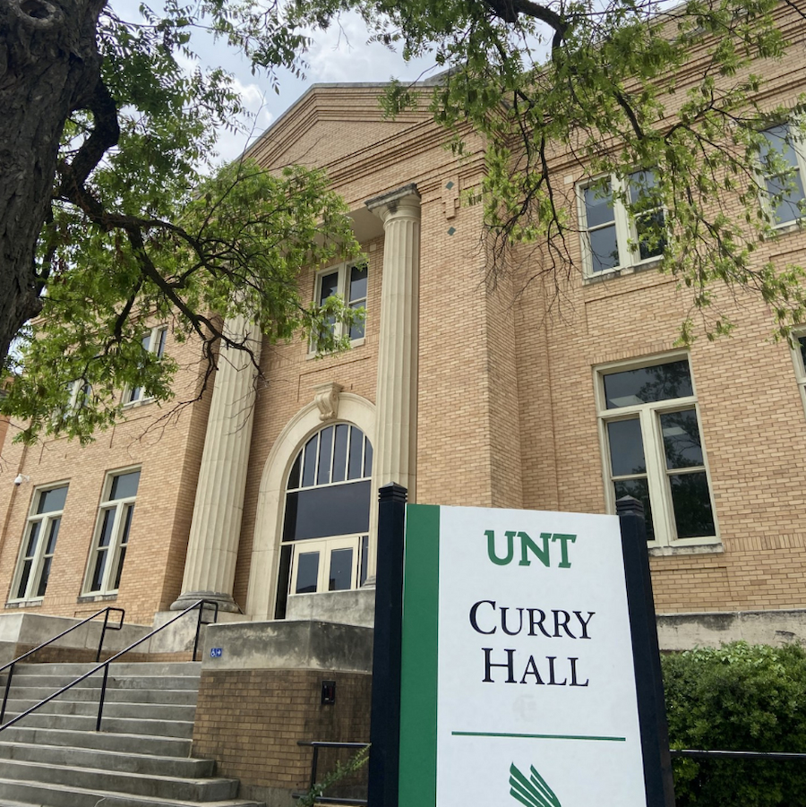 Outside view of Curry Hall with sign