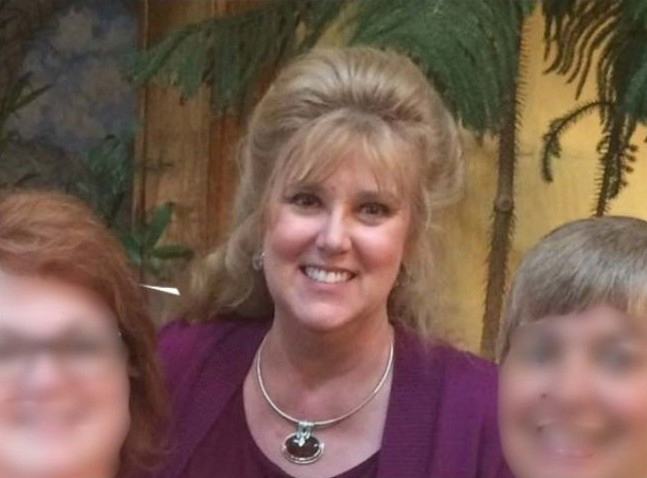 nancy terry in red against a green background